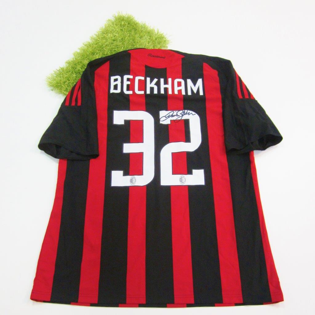 A framed and A.C. Milan football jersey signed by David Beckham